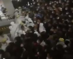 Dramatic moment THOUSANDS are herded into basement by hazmat staff at Shanghai airport after worker catches Covid