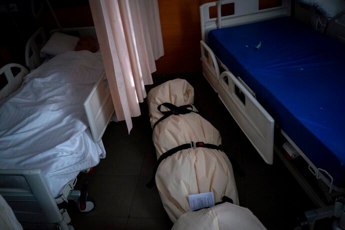 Covid victims wrapped in bedsheets left just inches from residents as Spain’s care homes feel brunt of second wave