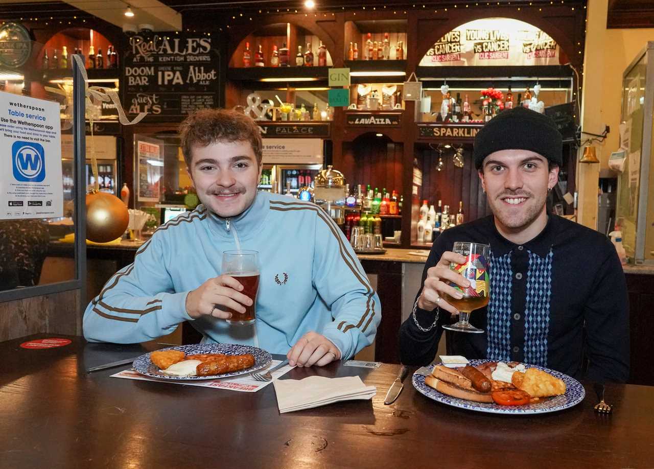 Happy customers Sam Adams, 20 (right) and Charles Burrows, 21, (left) enjoying a pub beer