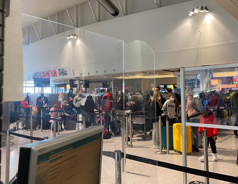 Covid fears at Heathrow after pictures show passengers packed together in snaking queues as Christmas getaway begins