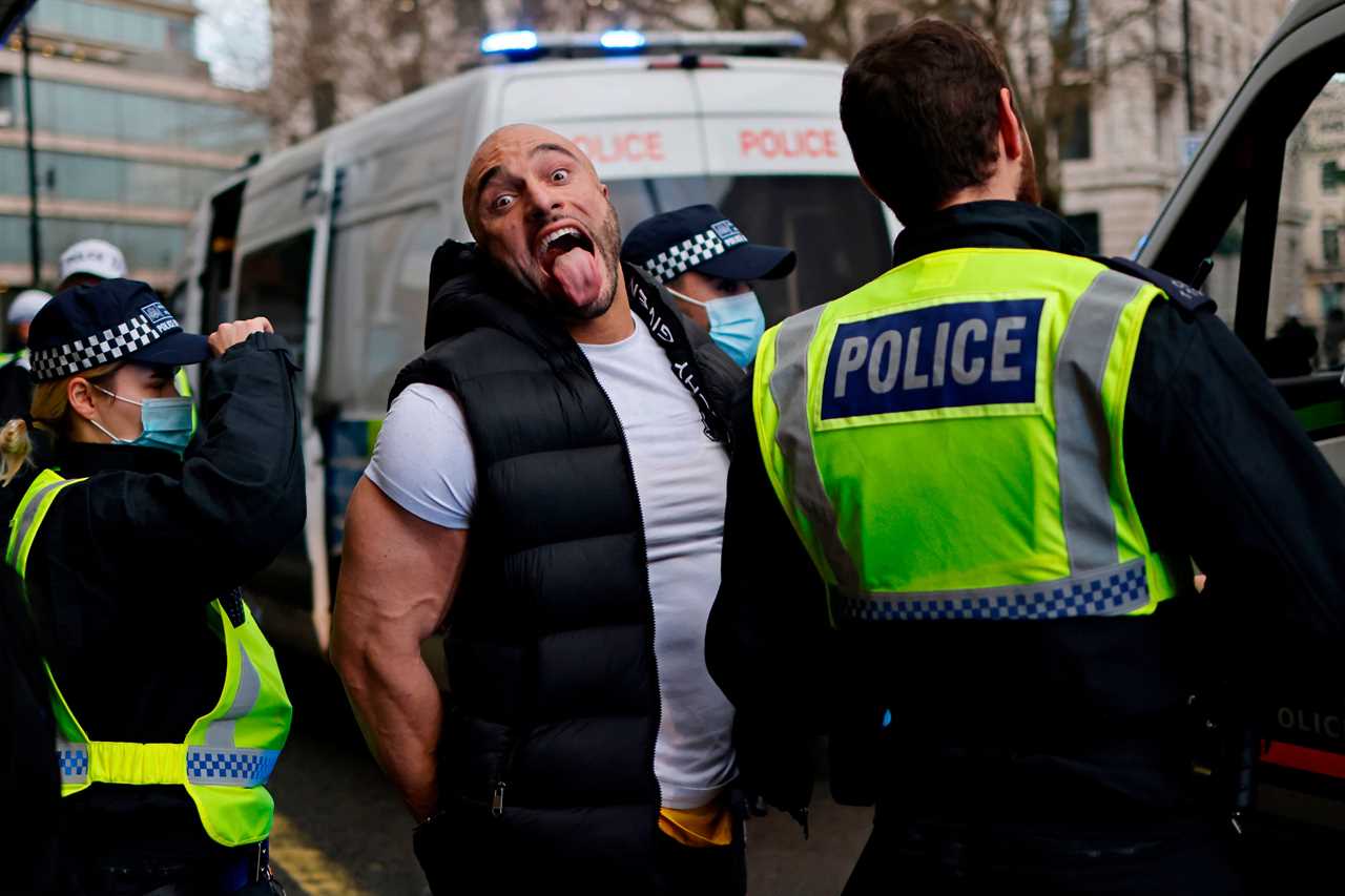 Chaos as 10 cops struggle to arrest huge bodybuilder who refused to close gym as anti-lockdown protest turns violent