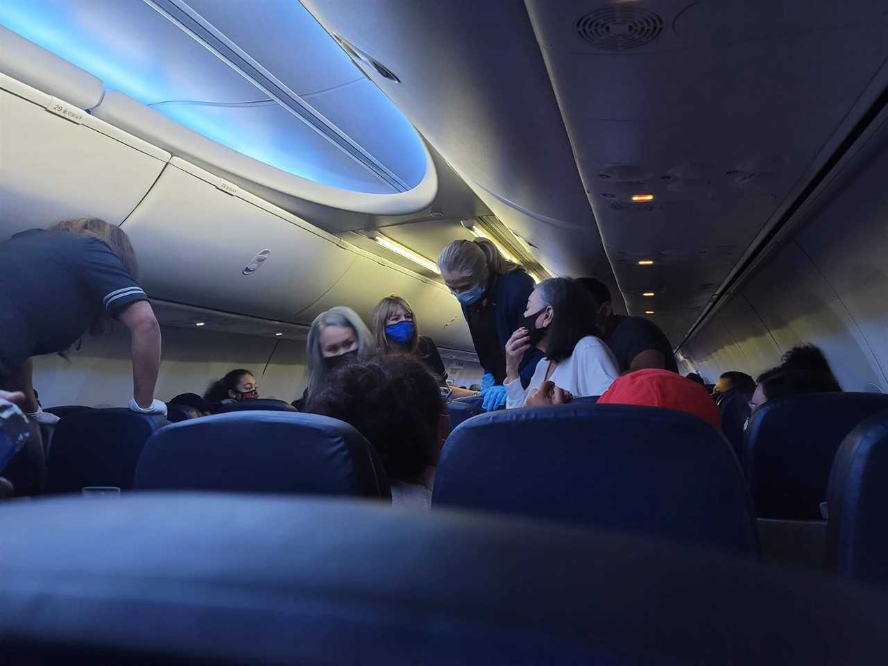 Man on United flight reveals he was ‘covered in sweat & urine after spending an HOUR trying to save Covid passenger’