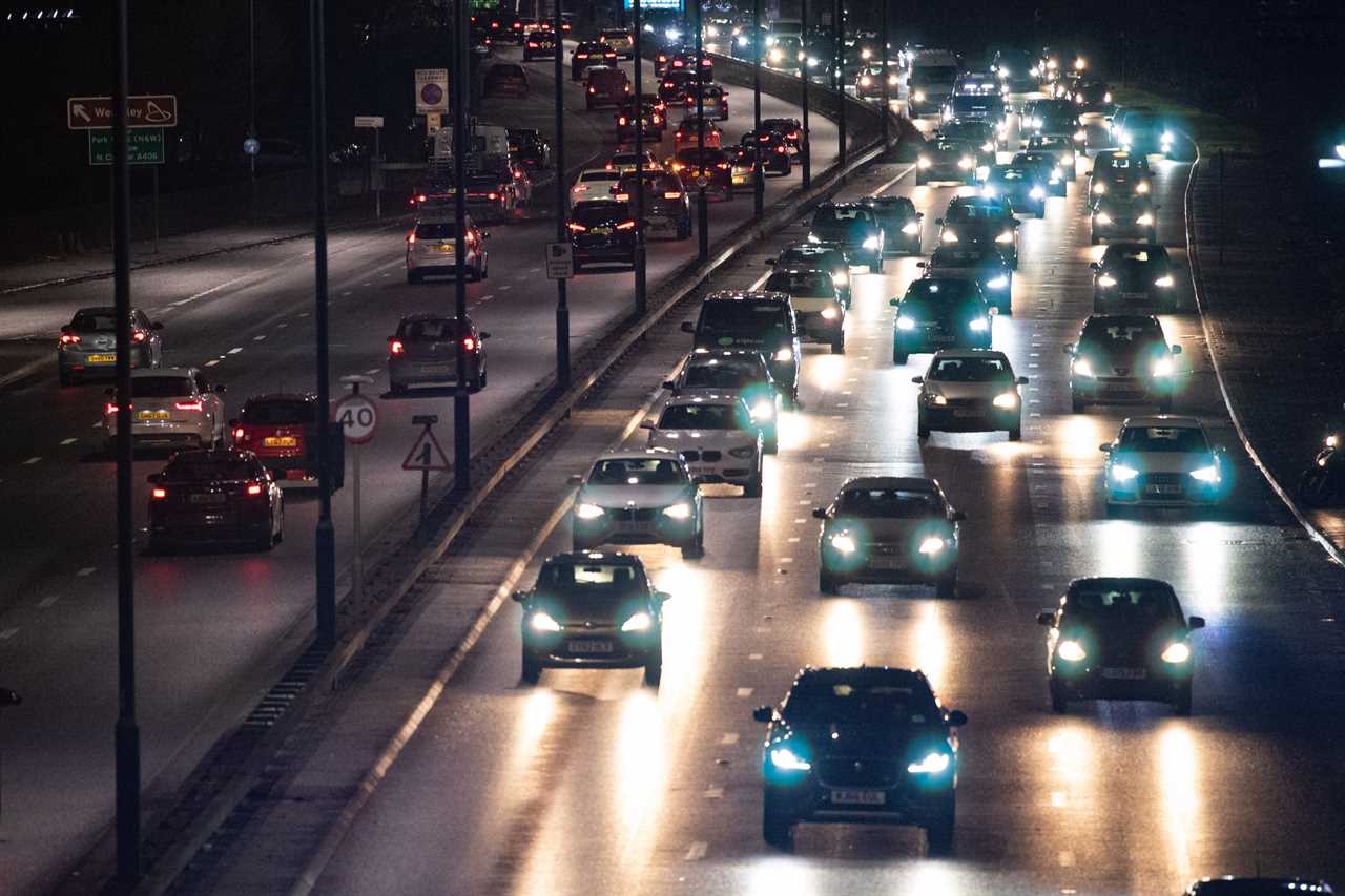 Traffic is seen on London's A40 last night as new coronavirus restrictions came into force at midnight