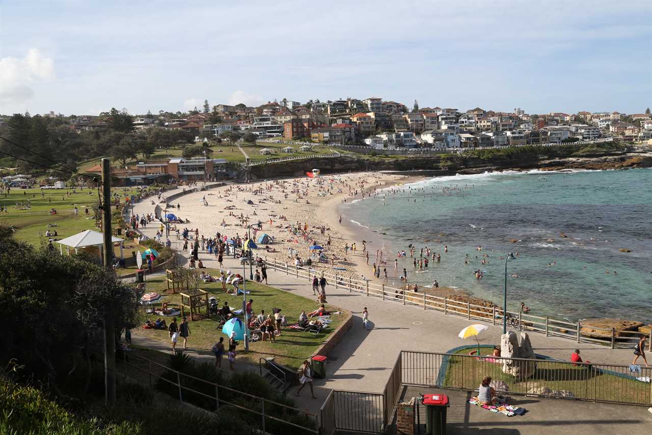 Hundreds of backpackers pictured breaking Covid rules at Christmas beach party in Australia face being deported