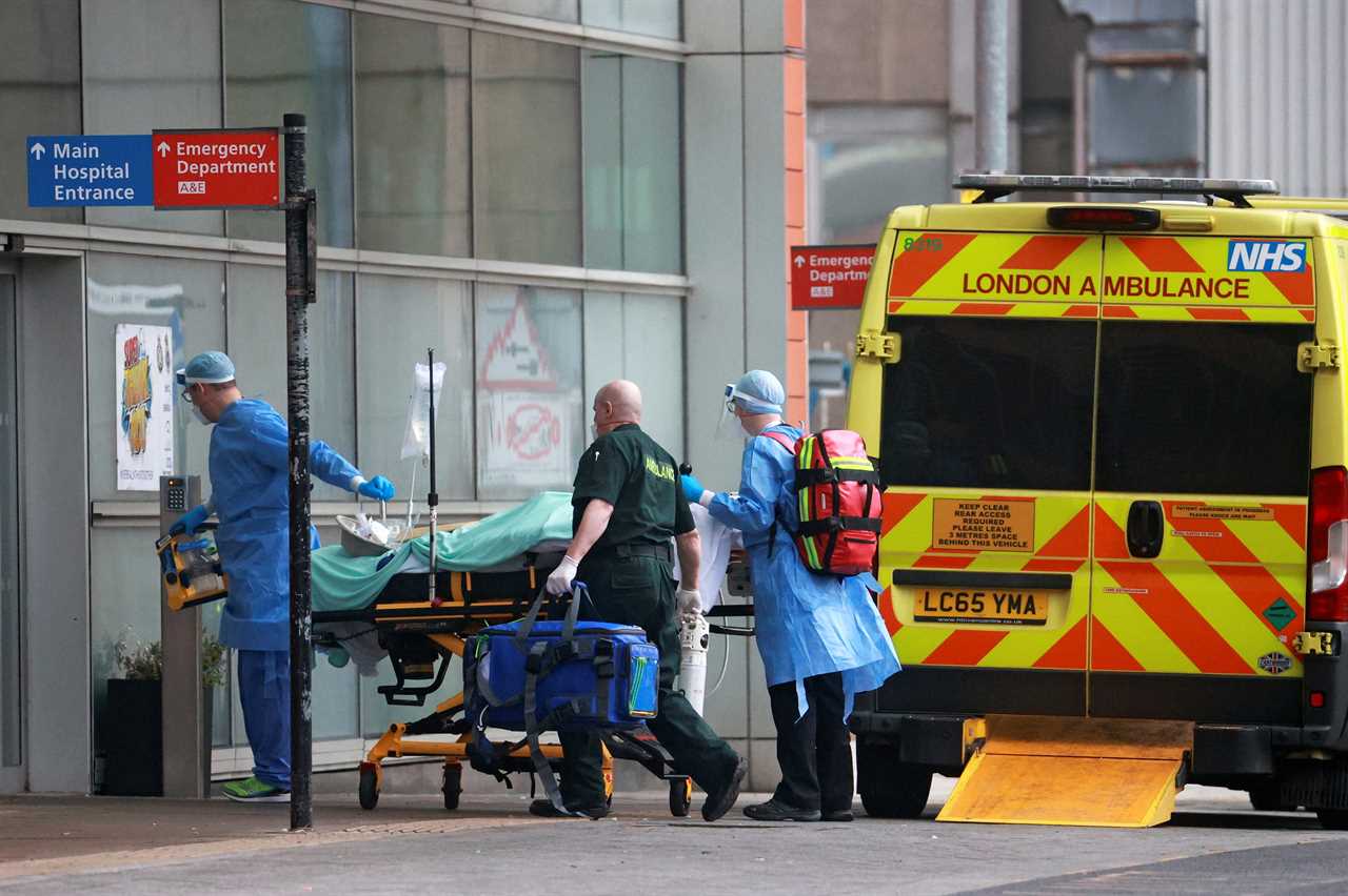 Medics transport a patient from an ambulance to the Royal London Hospital