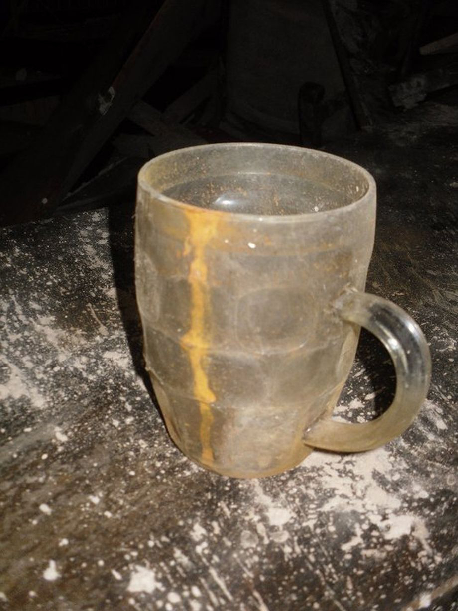 Inside pub frozen in time with empty pint glasses and bag of peanutstrapped underneath busy shopping centre