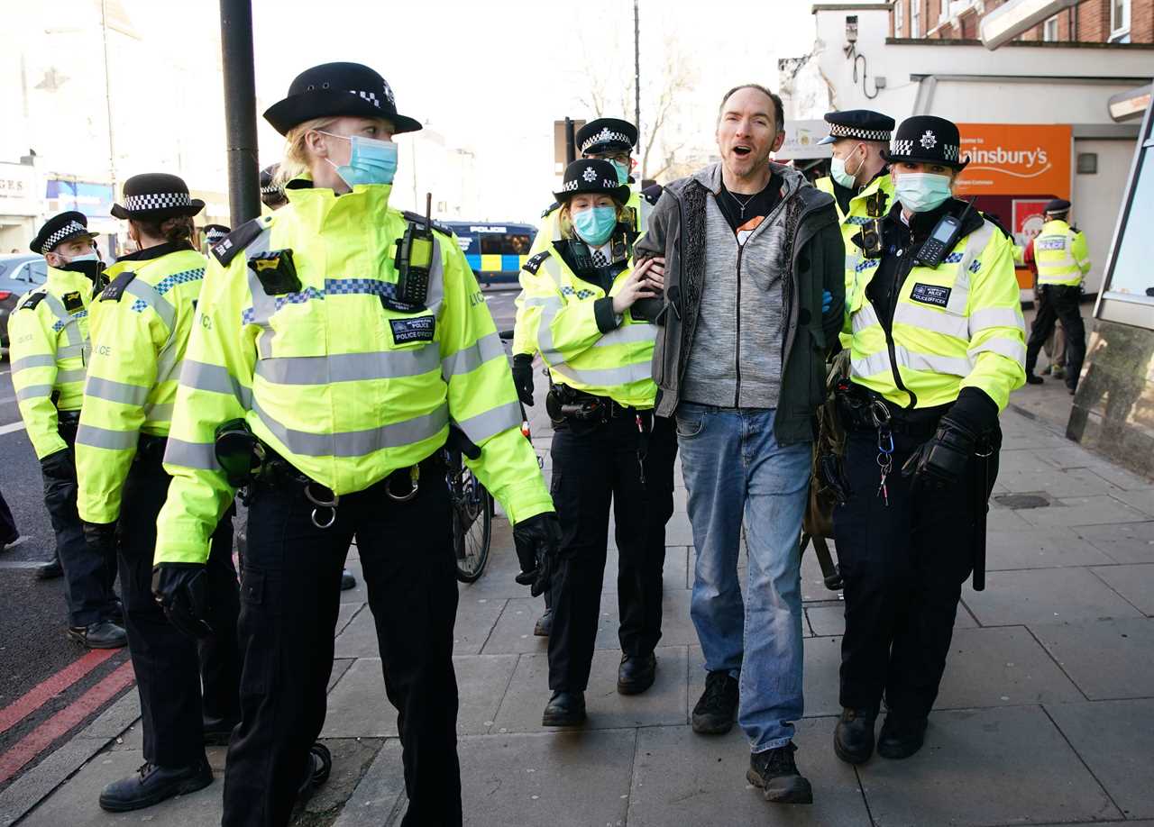 ‘Idiot’ anti-lockdown protesters clash with police 24 hours after Covid killed 1,325 on Britain’s deadliest day