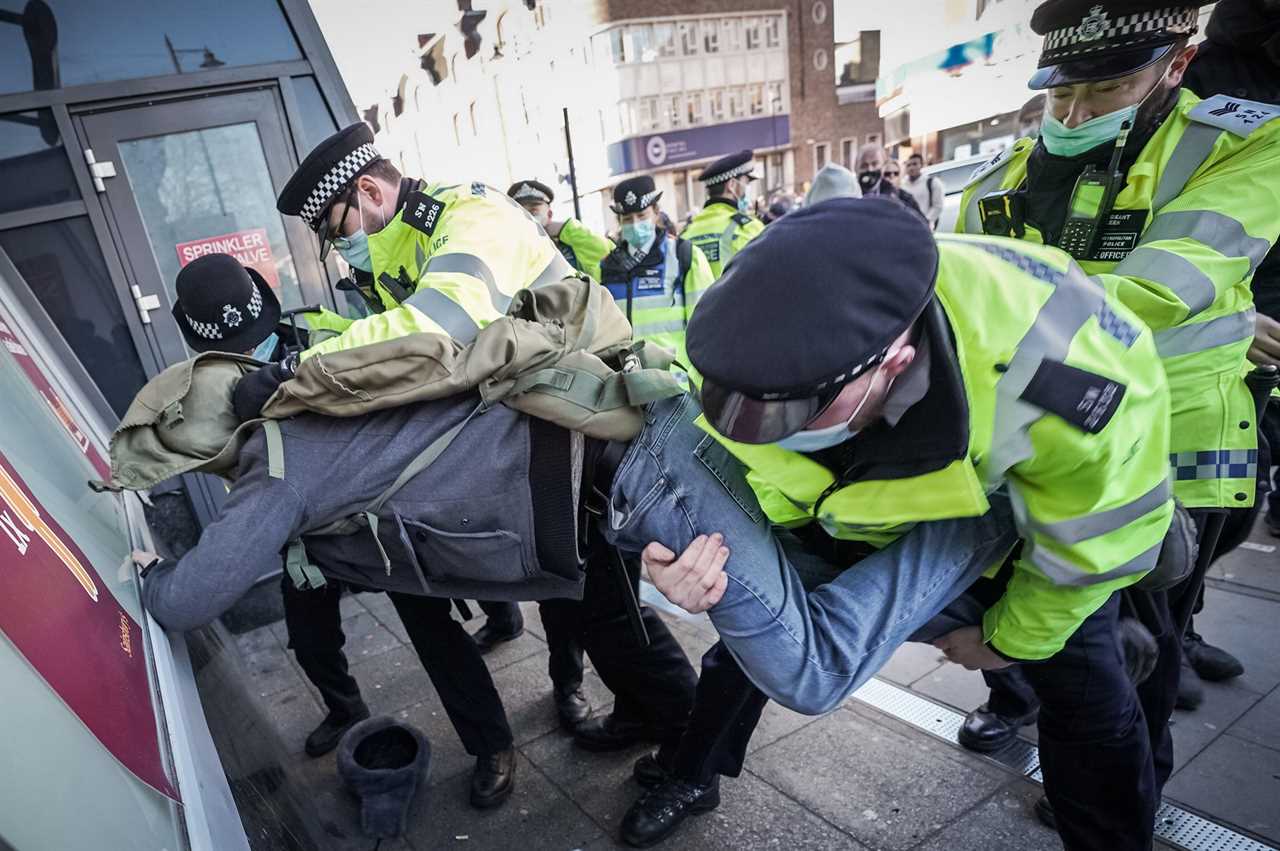 ‘Idiot’ anti-lockdown protesters clash with police 24 hours after Covid killed 1,325 on Britain’s deadliest day