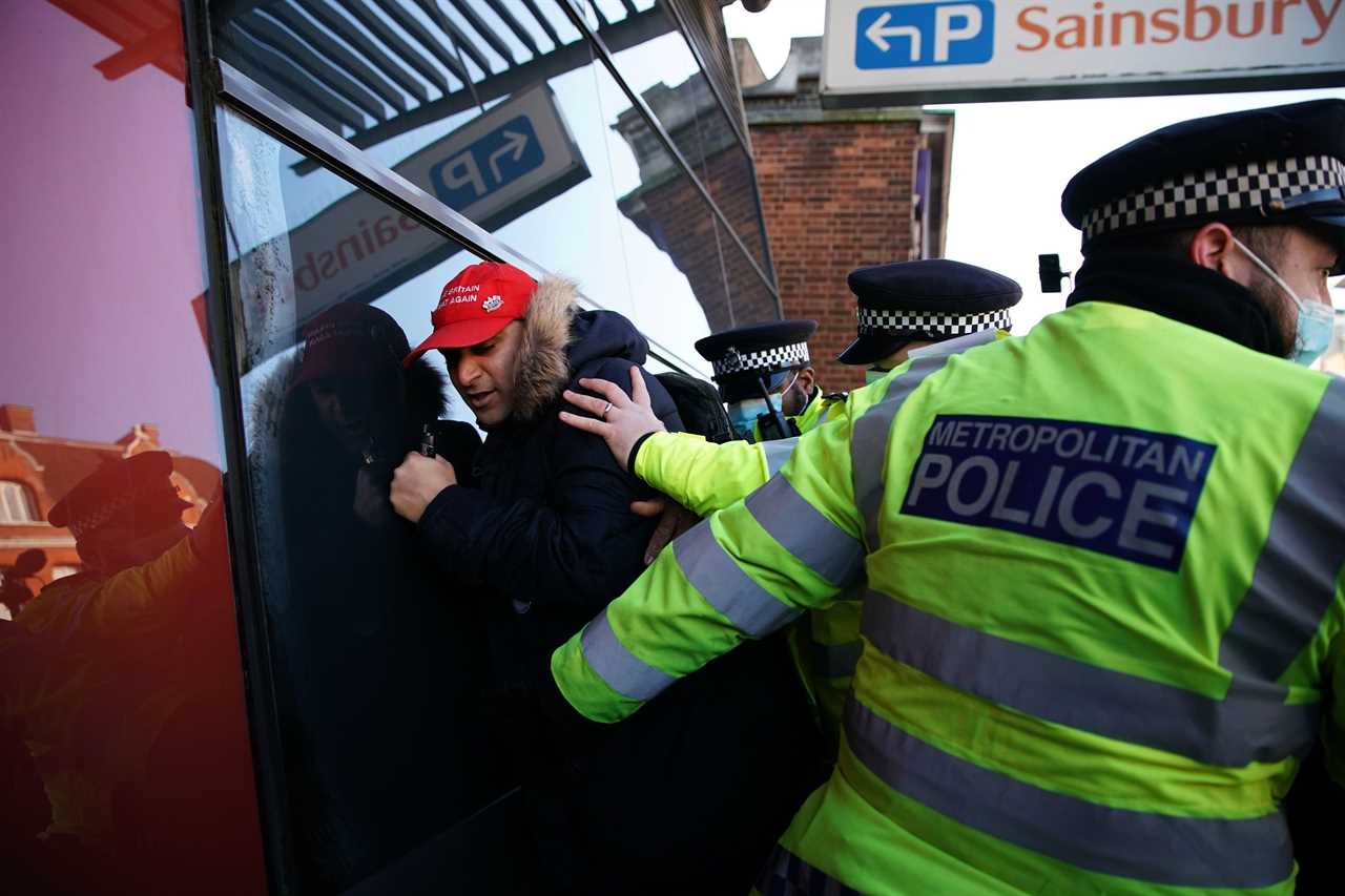 ‘Idiot’ anti-lockdown protesters clash with police 24 hours after Covid killed 1,325 on Britain’s deadliest day