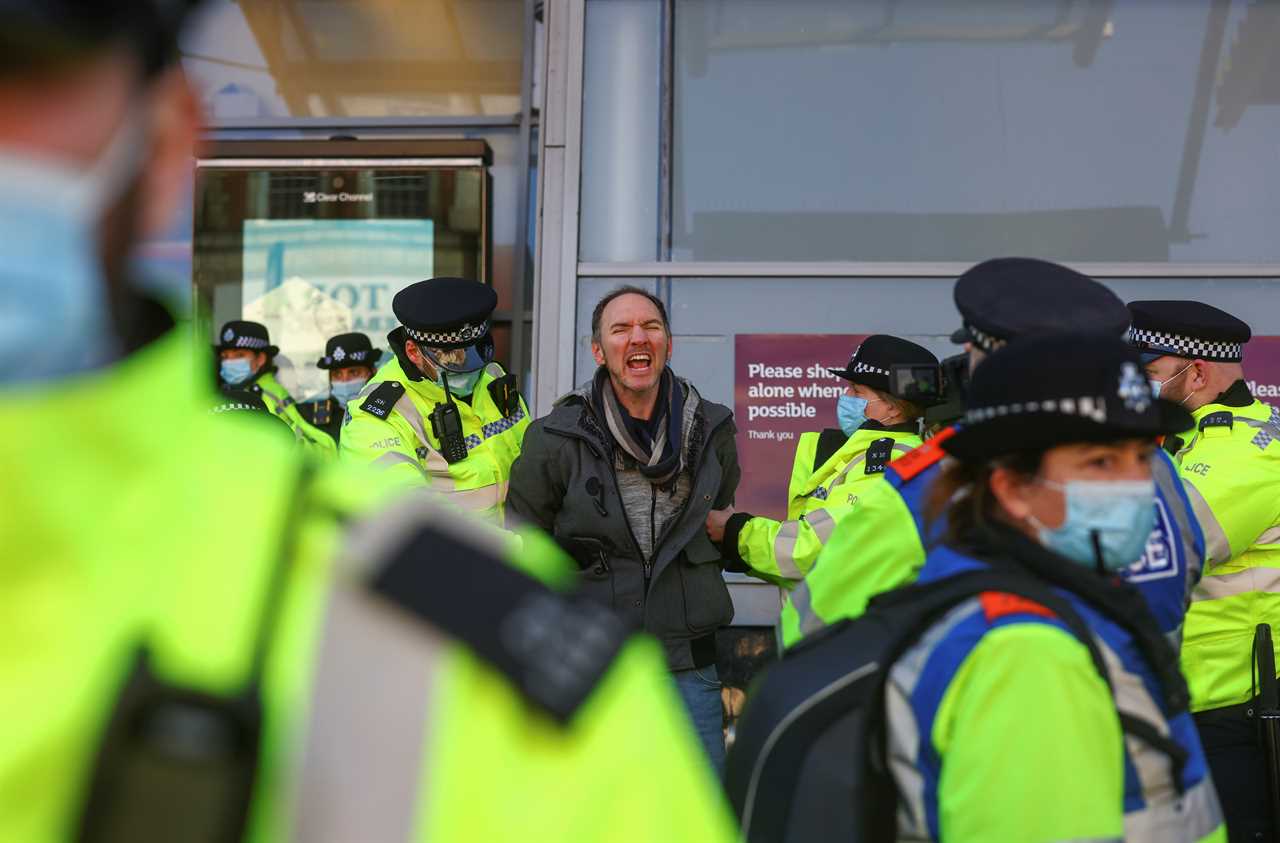 ‘Idiot’ anti-lockdown protesters clash with police 24 hours after Covid killed 1,325 on Britain’s deadliest day