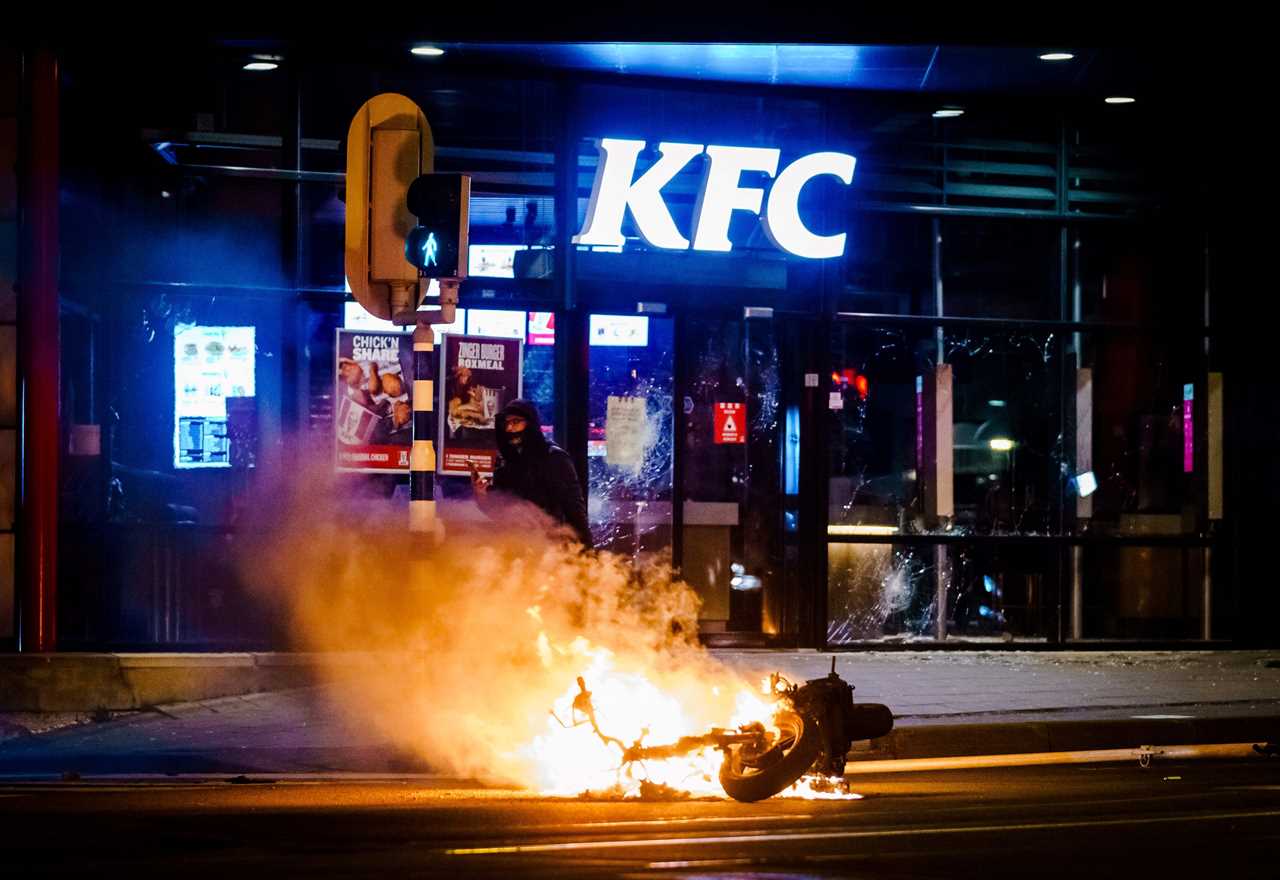 Anti-lockdown RIOTS as youths loot shops, flip cars and torch buildings over Covid curfew in the Netherlands