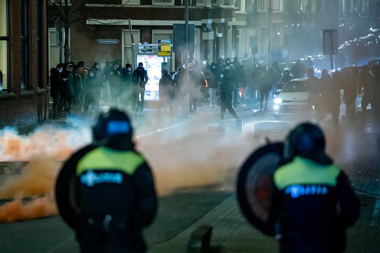 Anti-lockdown RIOTS as youths loot shops, flip cars and torch buildings over Covid curfew in the Netherlands