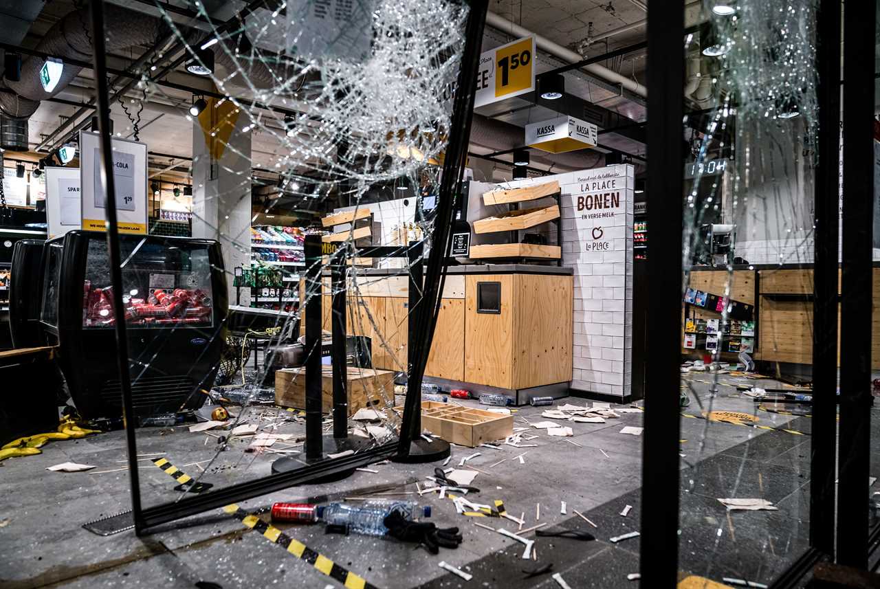 Anti-lockdown RIOTS as youths loot shops, flip cars and torch buildings over Covid curfew in the Netherlands