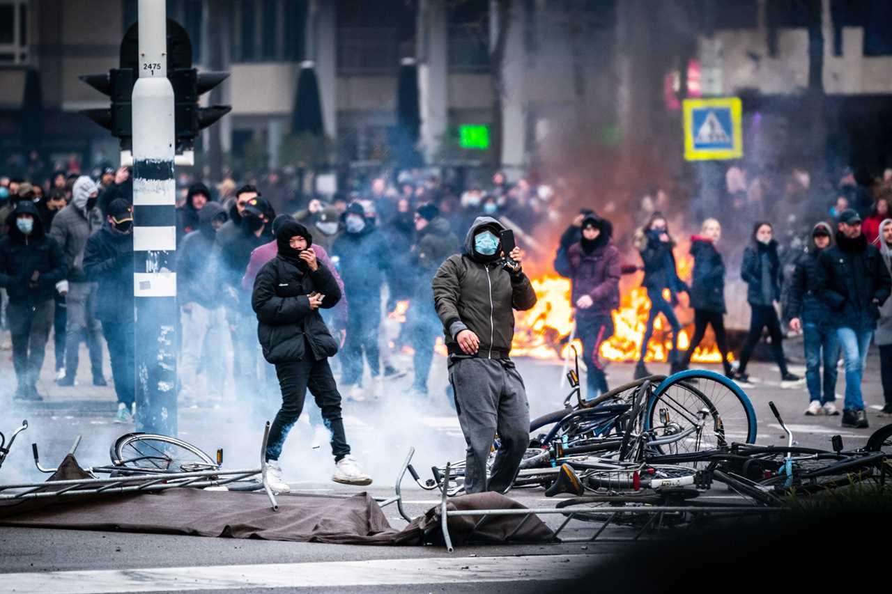 Anti-lockdown RIOTS as youths loot shops, flip cars and torch buildings over Covid curfew in the Netherlands