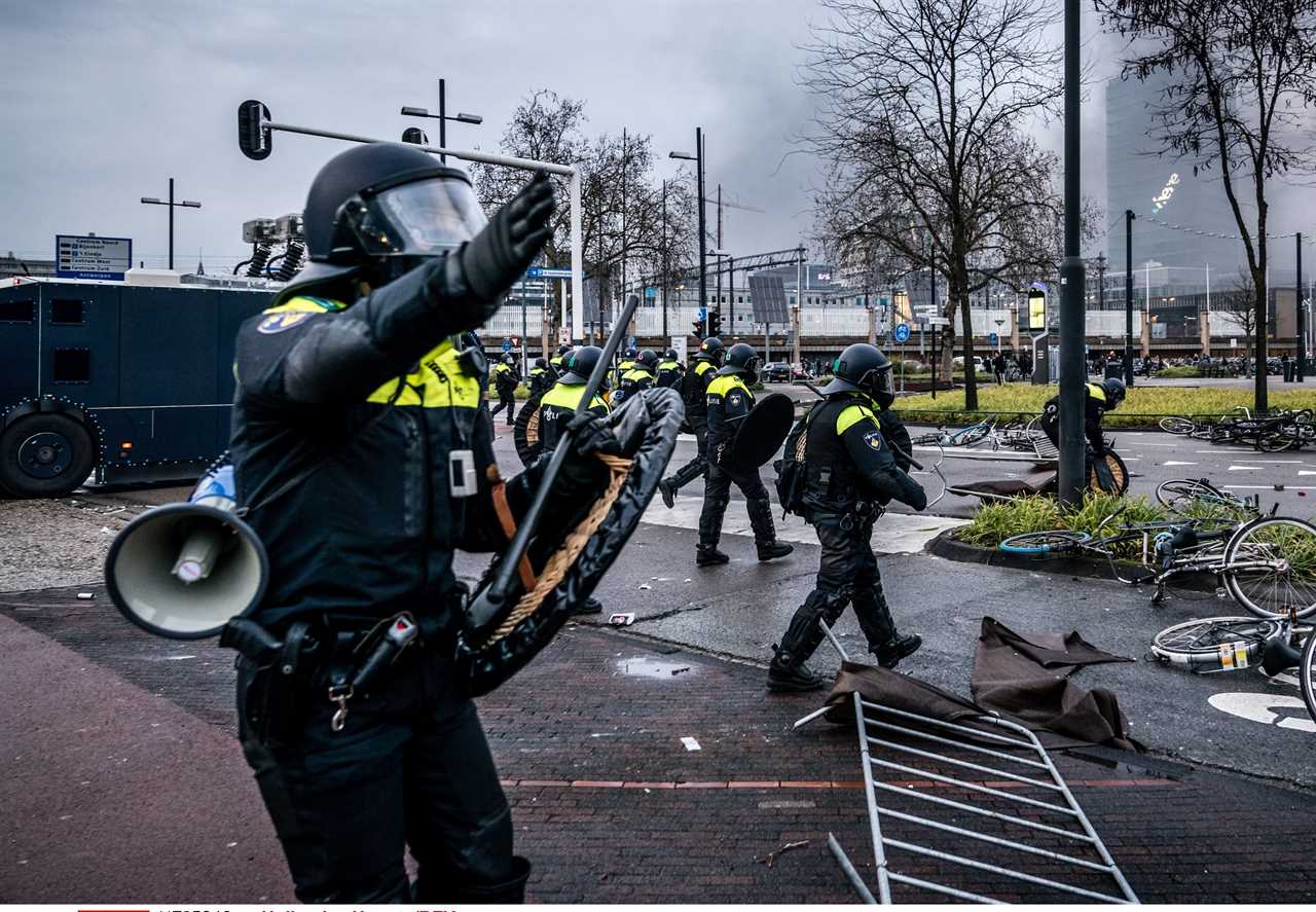 Anti-lockdown RIOTS as youths loot shops, flip cars and torch buildings over Covid curfew in the Netherlands