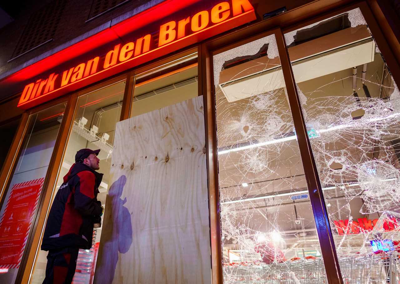 Anti-lockdown RIOTS as youths loot shops, flip cars and torch buildings over Covid curfew in the Netherlands