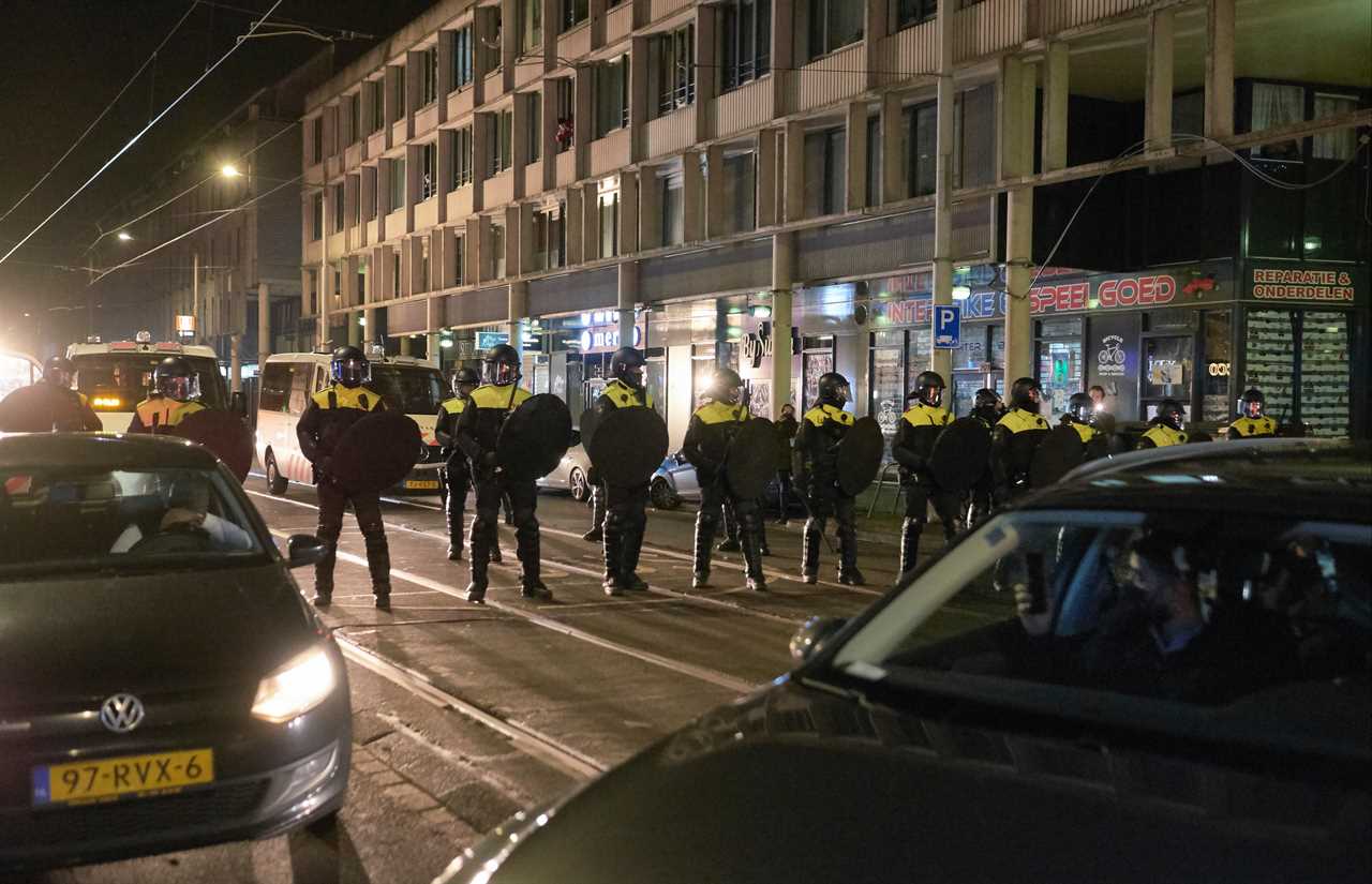 Anti-lockdown RIOTS as youths loot shops, flip cars and torch buildings over Covid curfew in the Netherlands