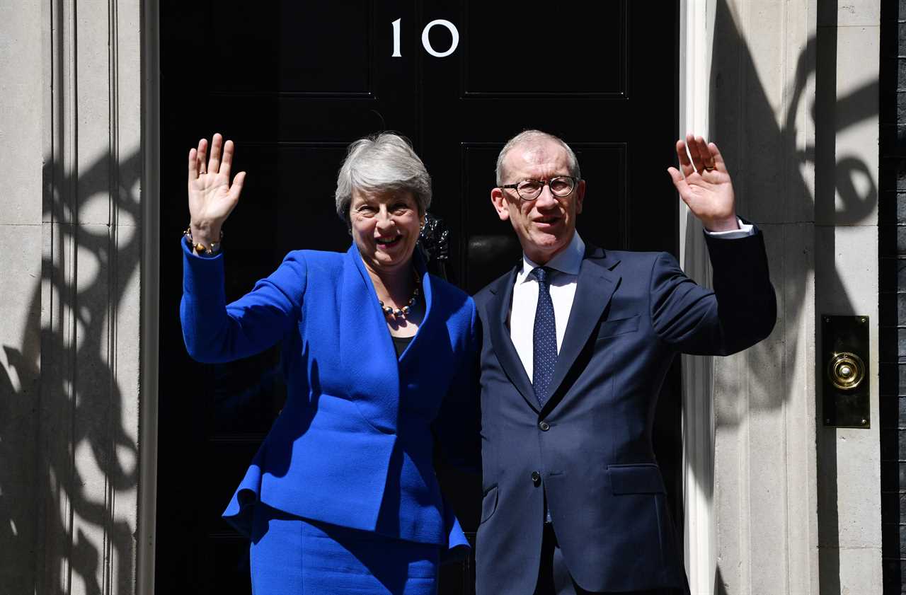 Worried Theresa May phoned her husband to say she was snapped holding hands with Donald Trump