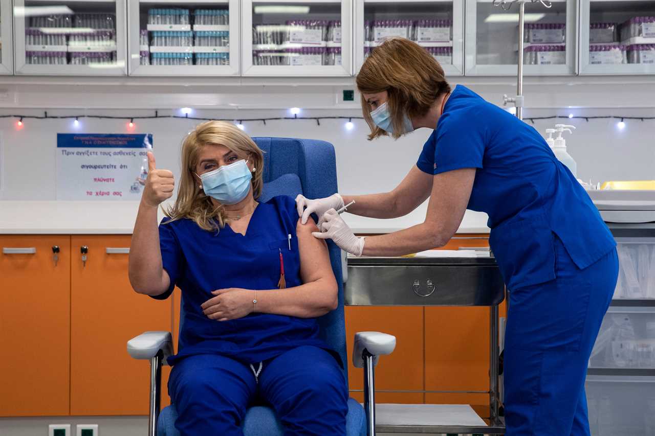 A Greek nurse gets her Covid vaccine in Athens