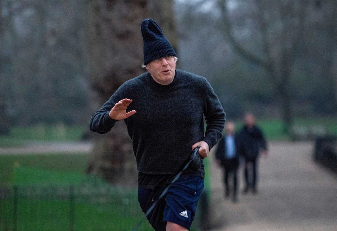 Boris Johnson dons his woolly hat as he heads out for a run with dog Dilyn