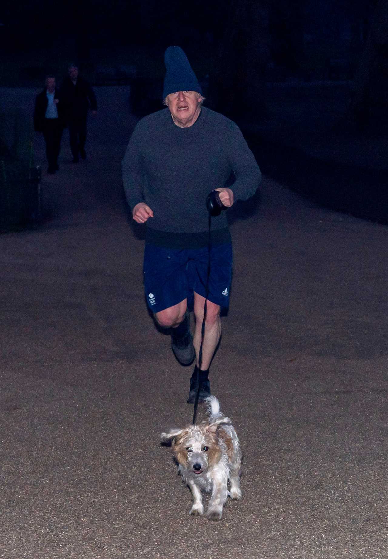 Boris Johnson dons his woolly hat as he heads out for a run with dog Dilyn