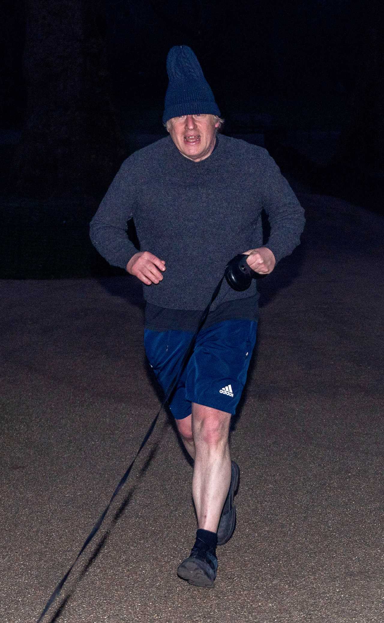 Boris Johnson dons his woolly hat as he heads out for a run with dog Dilyn