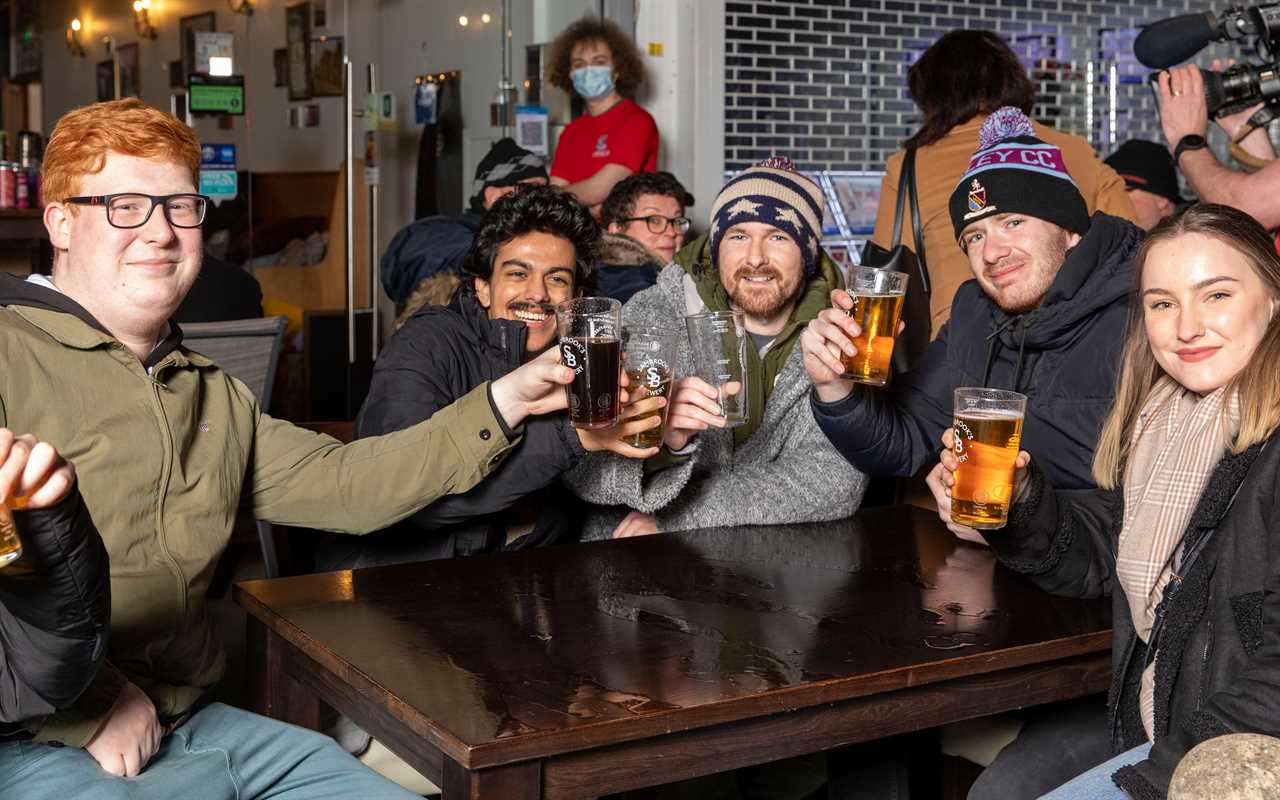 Thirsty Brits brave SNOW & queue from midnight in -3C temperatures as pub beer gardens reopen for first time in months