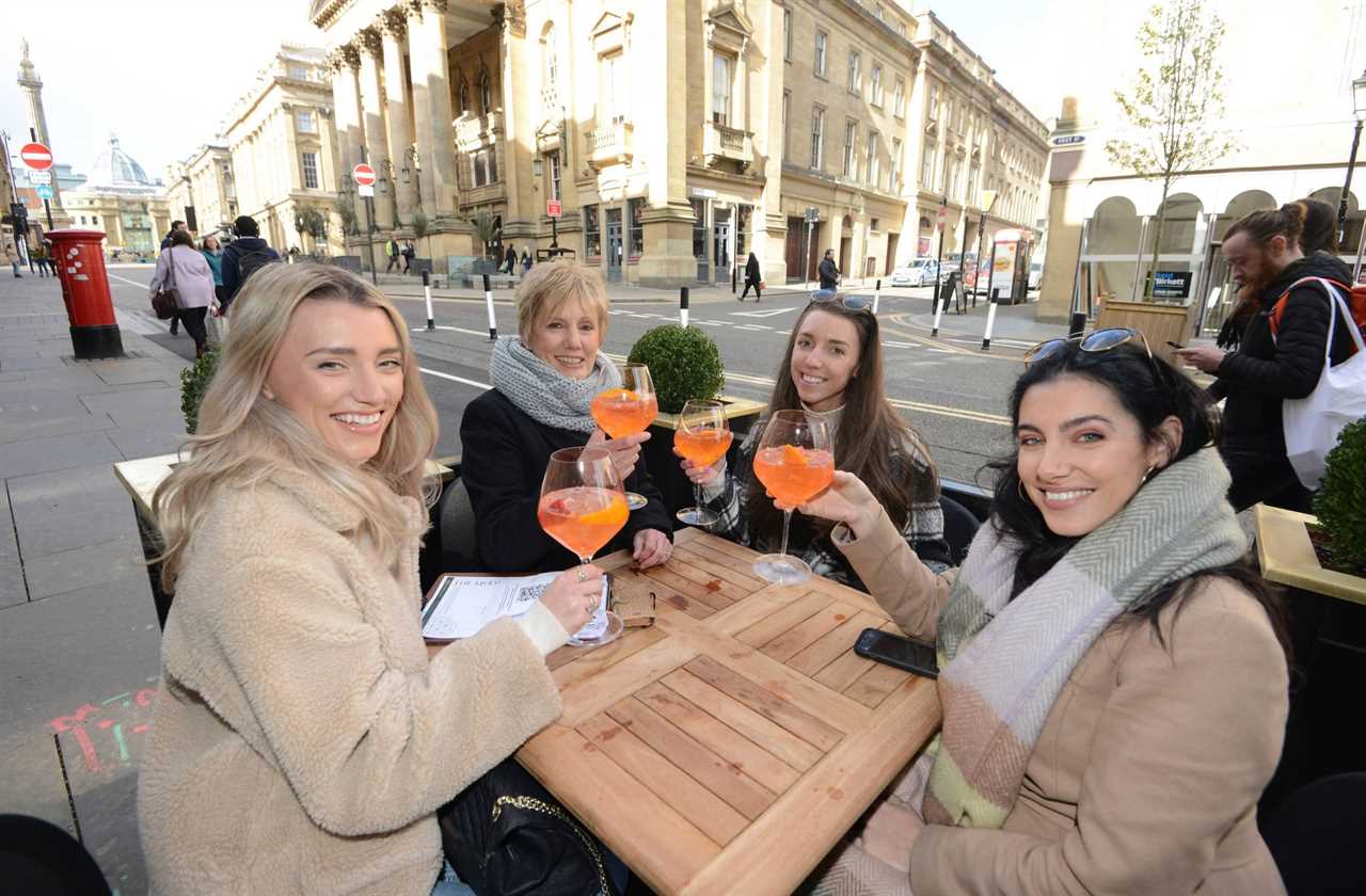 Thirsty Brits brave SNOW & queue from midnight in -3C temperatures as pub beer gardens reopen for first time in months