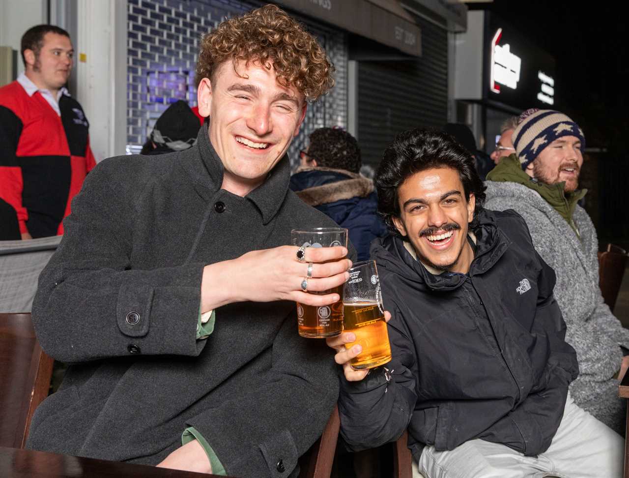 Thirsty Brits brave SNOW & queue from midnight in -3C temperatures as pub beer gardens reopen for first time in months