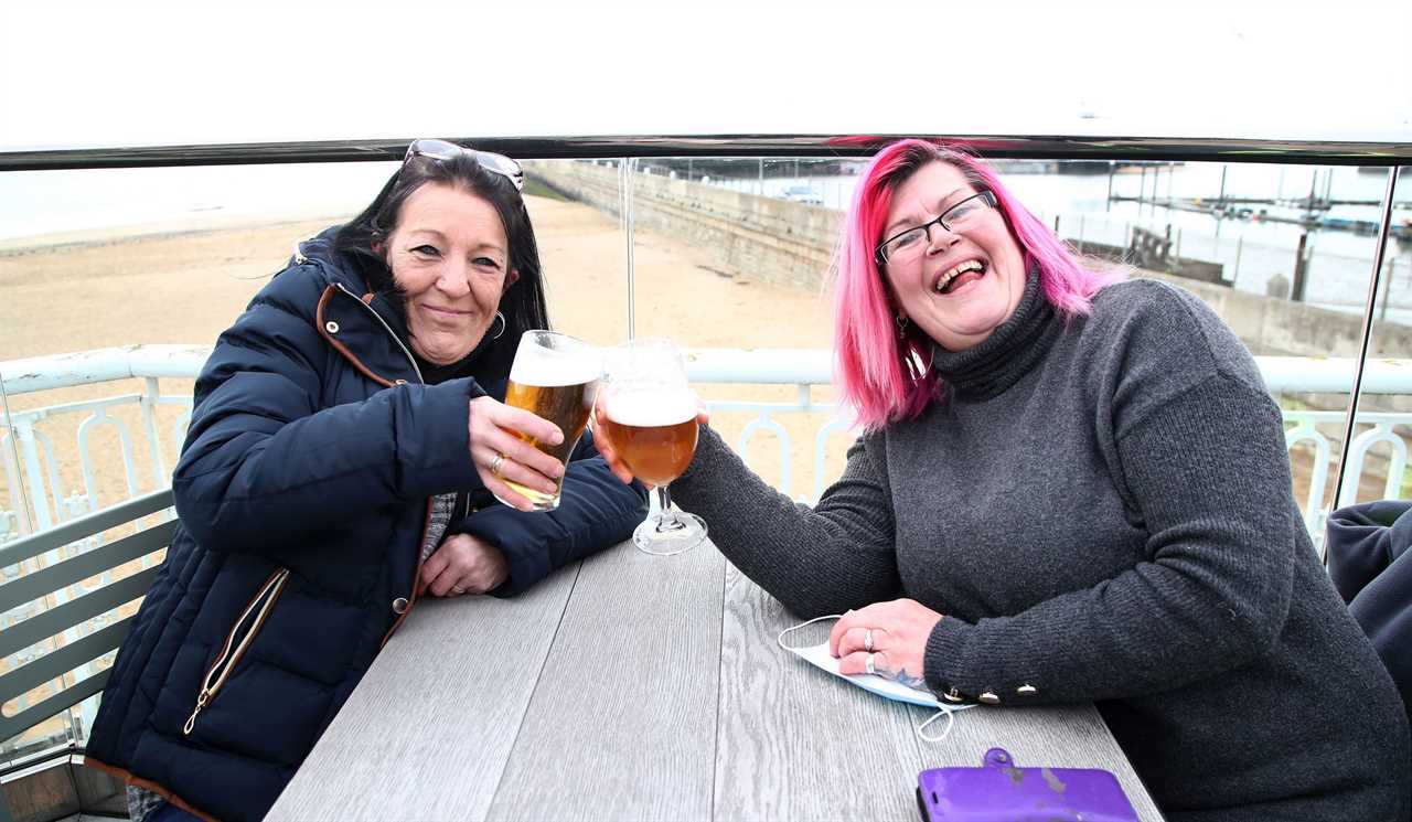 Thirsty Brits brave SNOW & queue from midnight in -3C temperatures as pub beer gardens reopen for first time in months