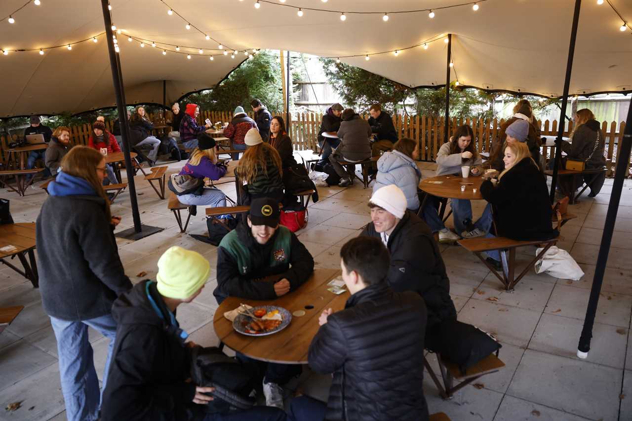 Thirsty Brits brave SNOW & queue from midnight in -3C temperatures as pub beer gardens reopen for first time in months