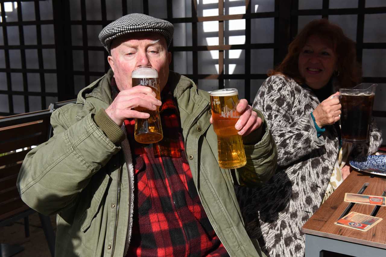 Thirsty Brits brave SNOW & queue from midnight in -3C temperatures as pub beer gardens reopen for first time in months