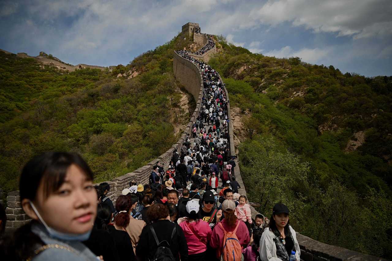 Tourists pack together on Great Wall of China with no face masks or social distancing as Beijing declares Covid victory