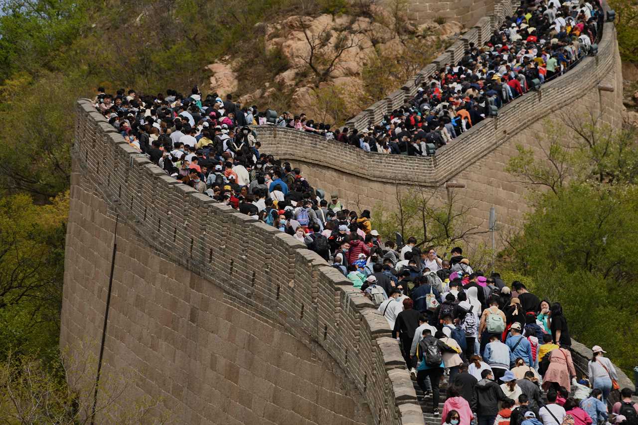 Tourists pack together on Great Wall of China with no face masks or social distancing as Beijing declares Covid victory