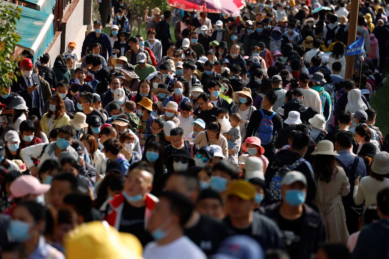 Tourists pack together on Great Wall of China with no face masks or social distancing as Beijing declares Covid victory