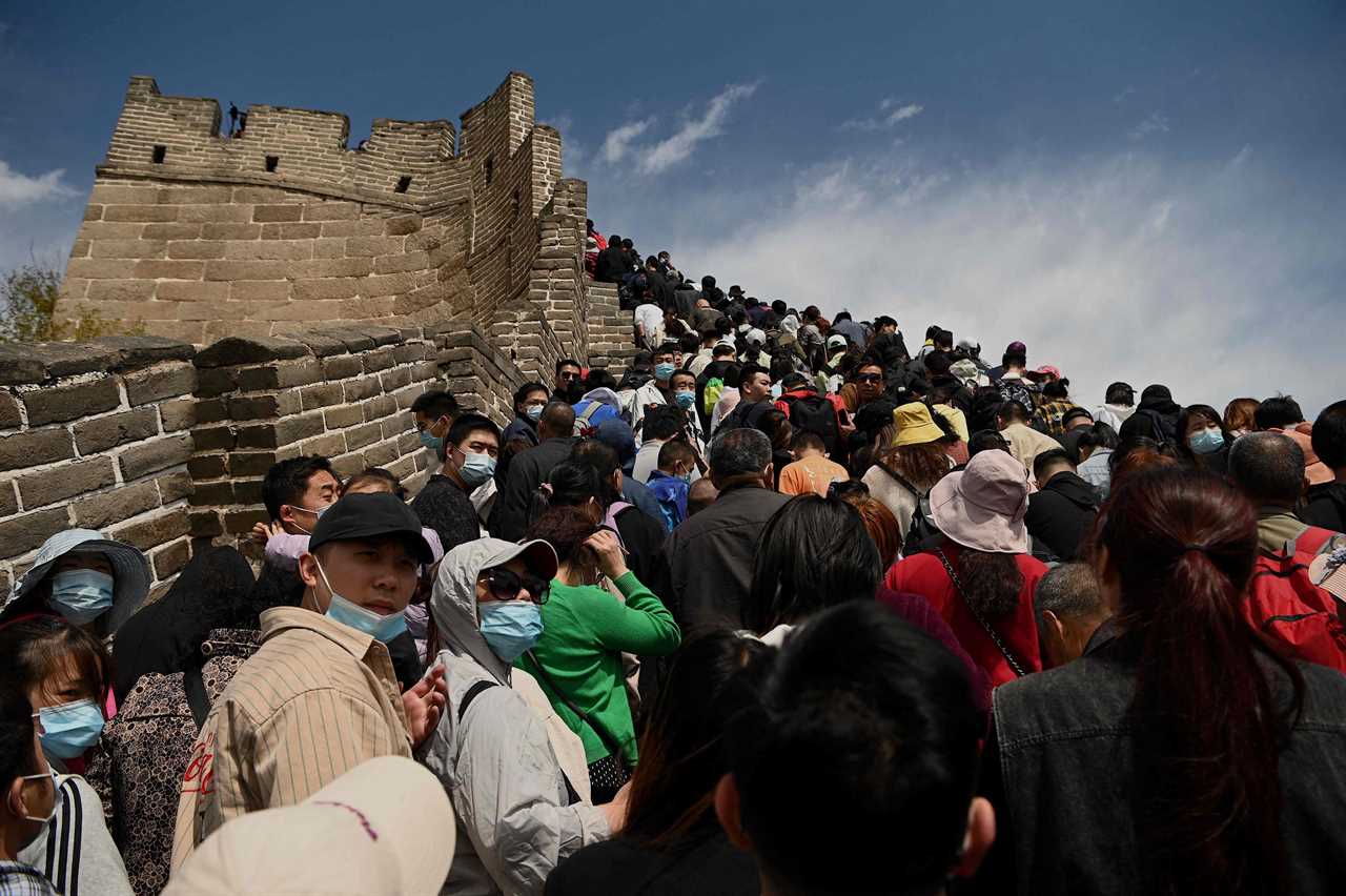 Tourists pack together on Great Wall of China with no face masks or social distancing as Beijing declares Covid victory