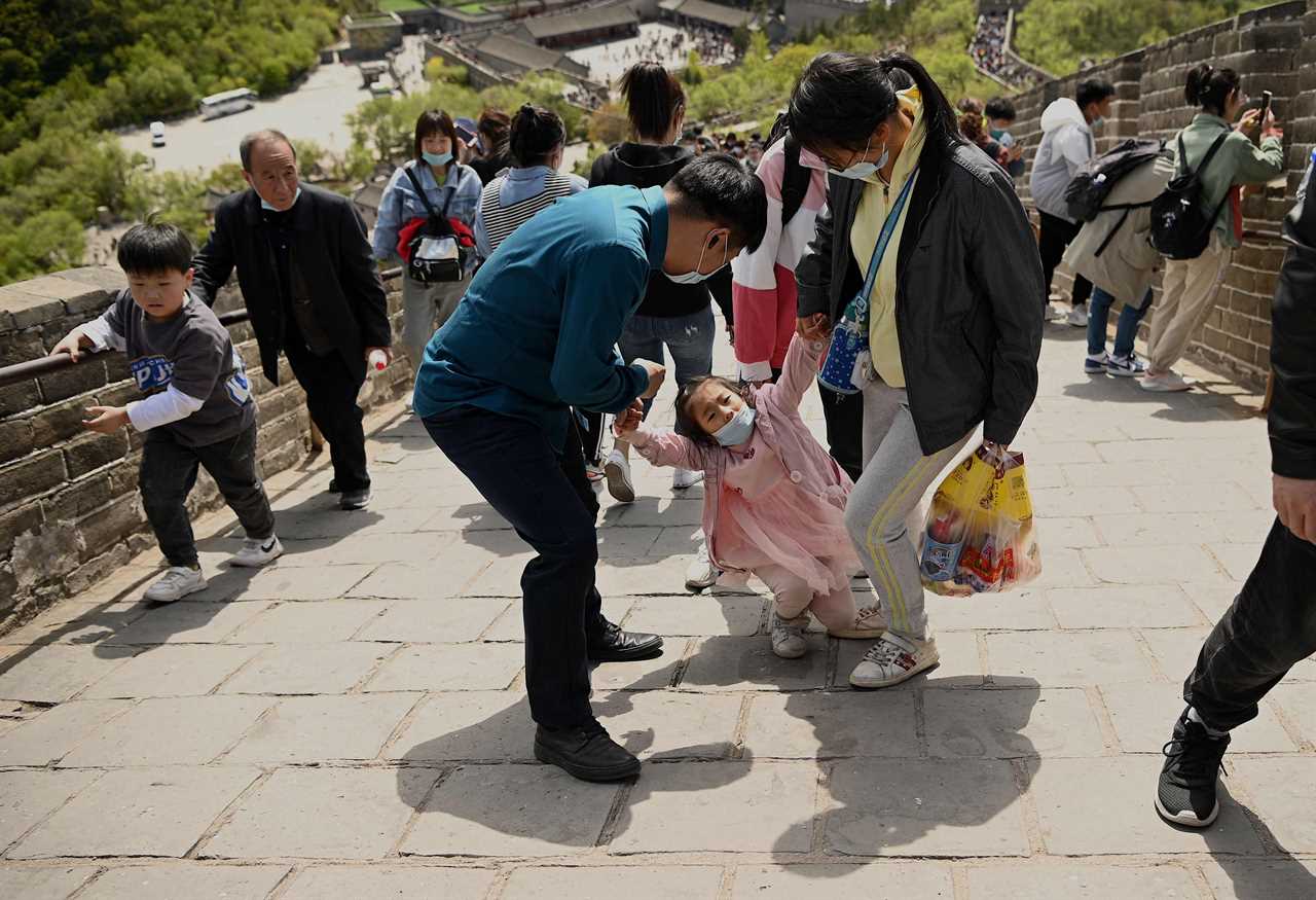 Tourists pack together on Great Wall of China with no face masks or social distancing as Beijing declares Covid victory