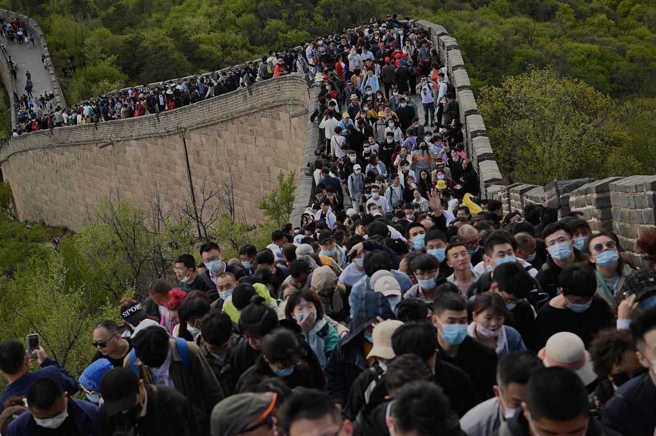 Tourists pack together on Great Wall of China with no face masks or social distancing as Beijing declares Covid victory