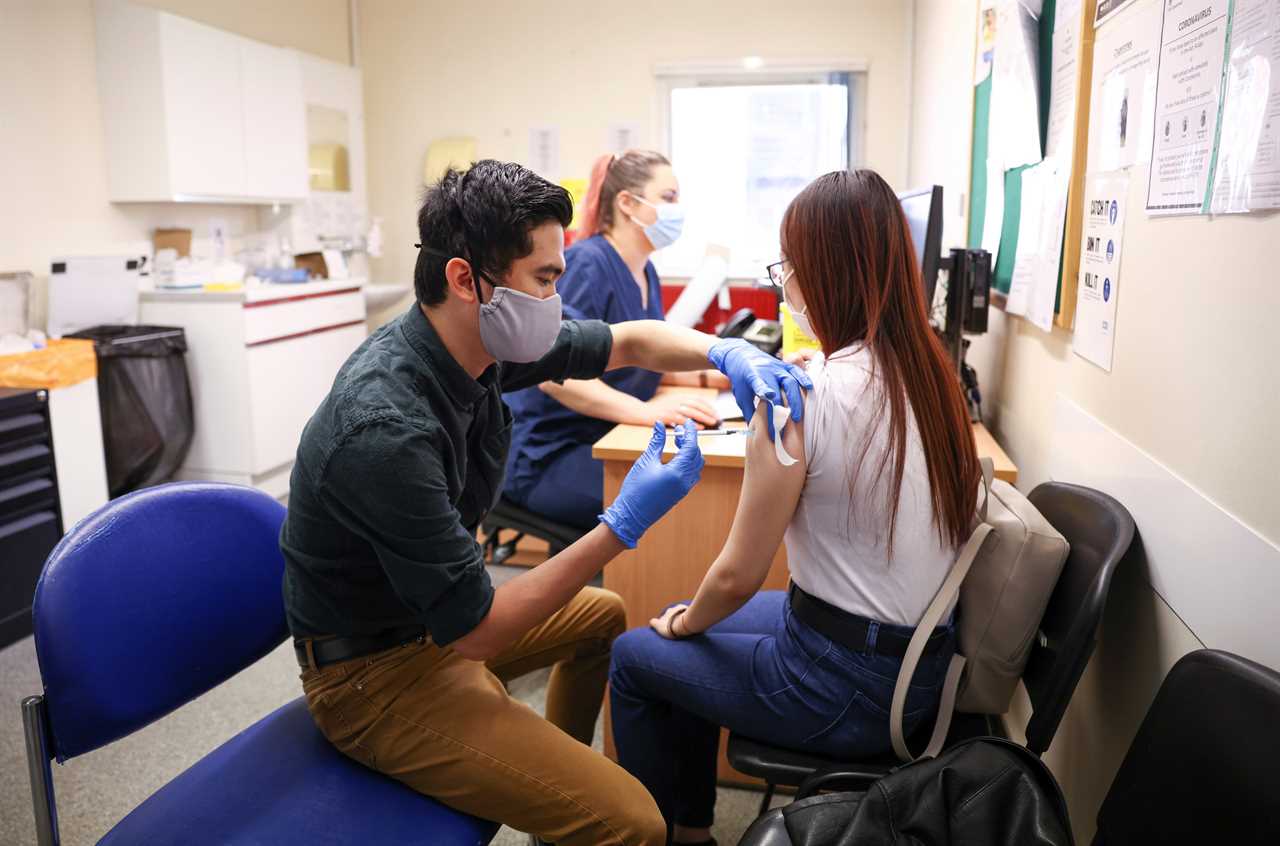 A woman receives a dose of the Pfizer BioNTech vaccine in London