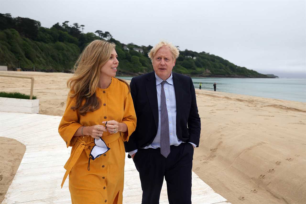 Boris Johnson and Carrie Symonds on first public outing together since they wed as they hit the beach in Cornwall