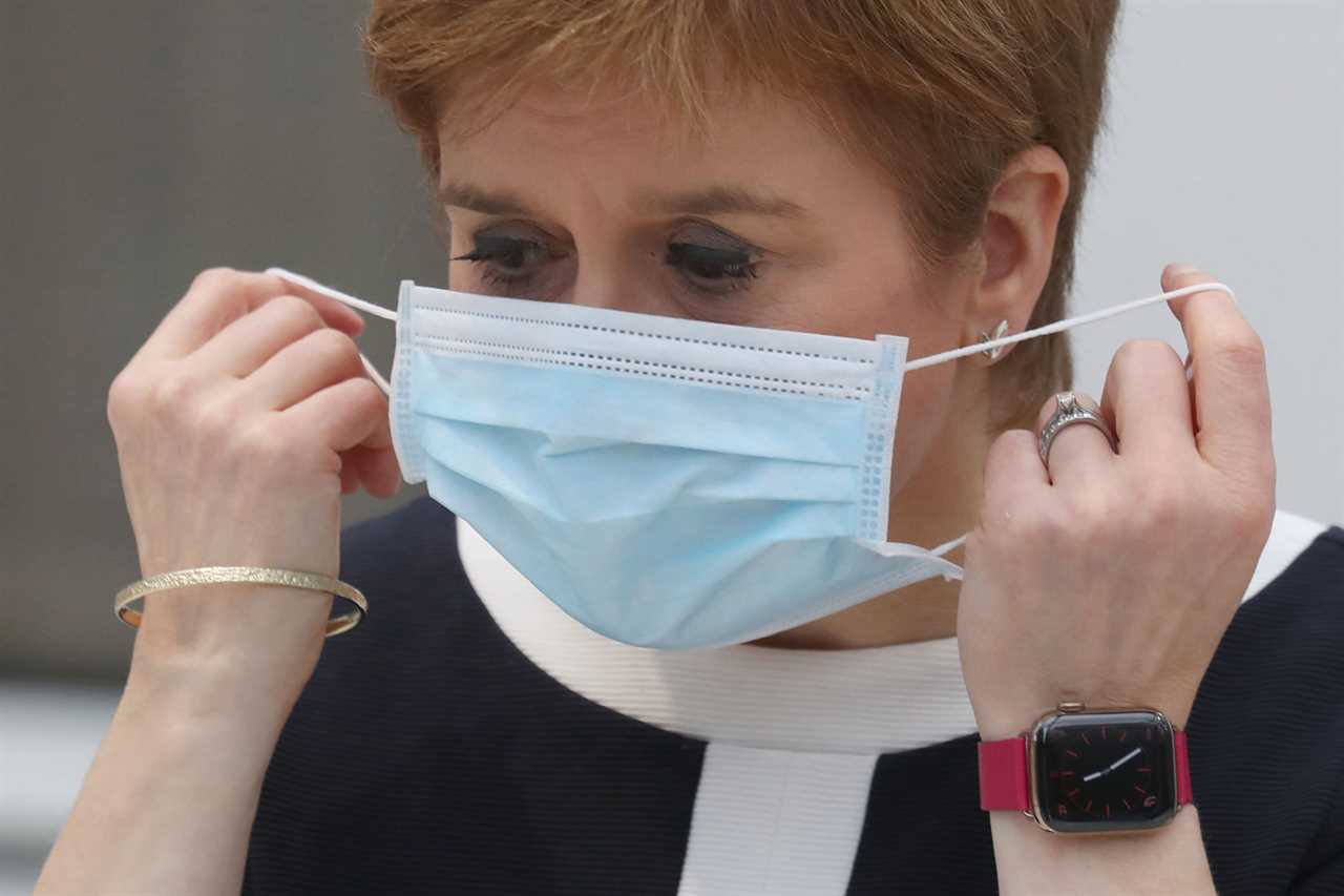 Scots will have to carry on wearing face masks for ‘some time’ in pubs and schools, says Sturgeon, as she ends lockdown