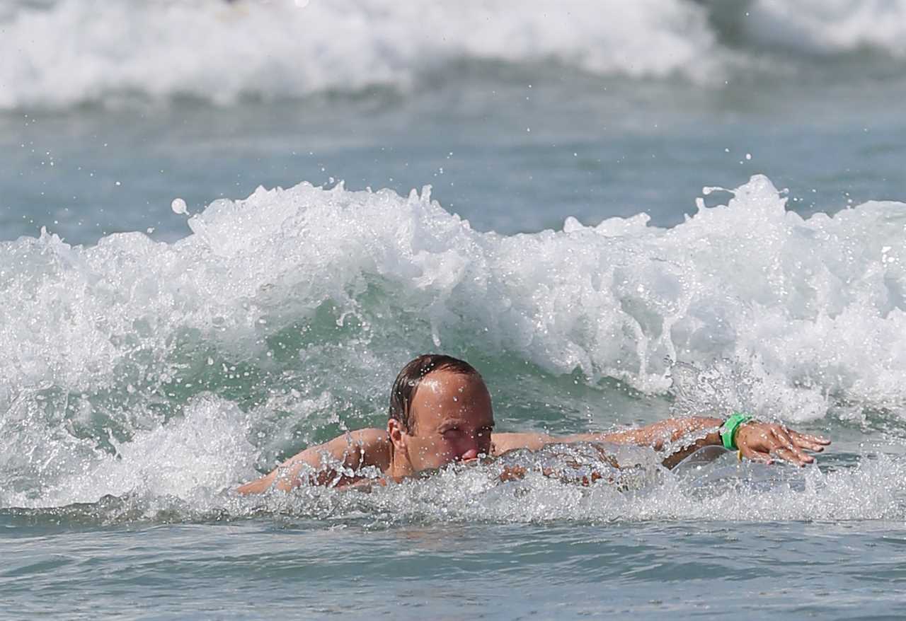 Washed-up Matt Hancock makes a splash with a bodyboard on seaside holiday with his kids and estranged wife Martha