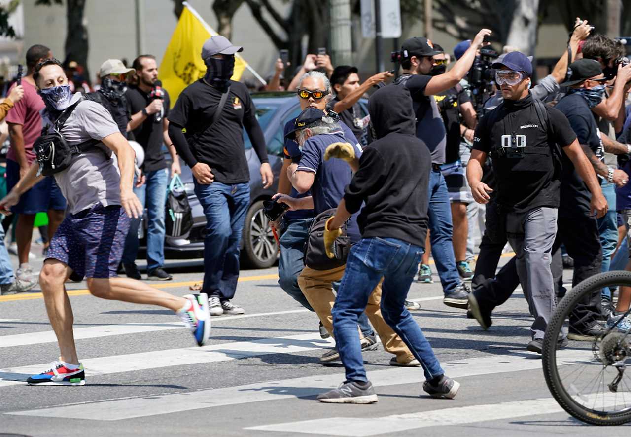 Man stabbed as hundreds of anti-vaccine protesters and Antifa brawl outside Los Angeles City Hall