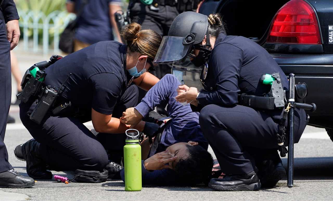 Man stabbed as hundreds of anti-vaccine protesters and Antifa brawl outside Los Angeles City Hall