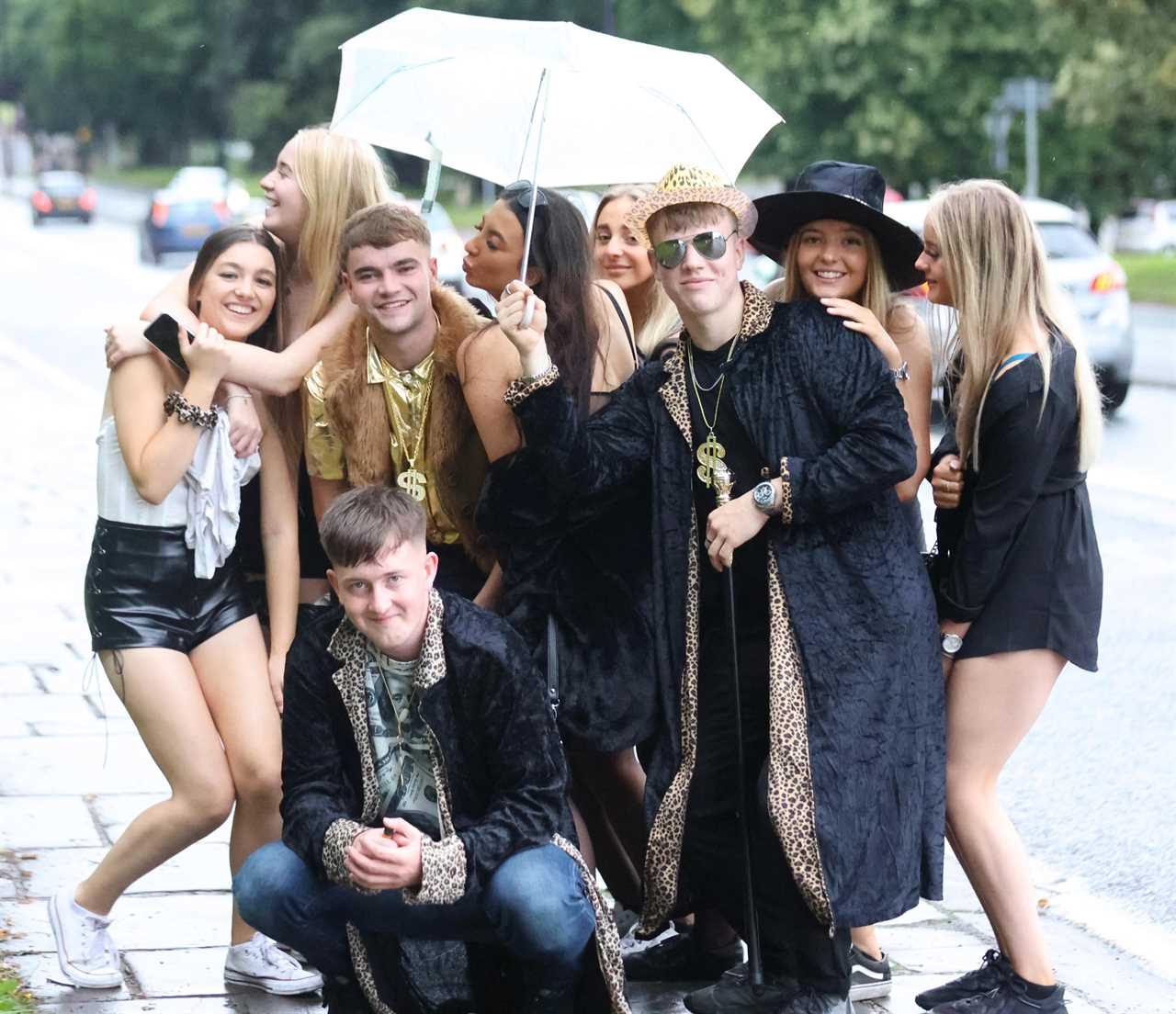 Revellers grin as they brave the rain to hit nightclubs and bars on wet night out