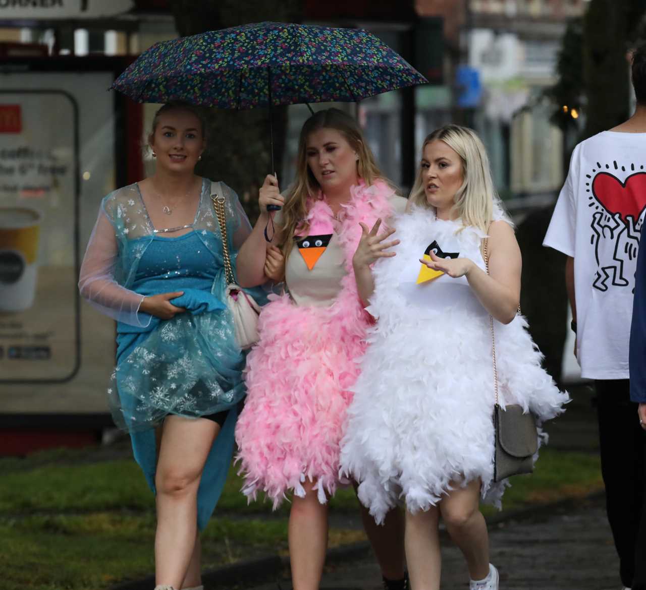 Revellers grin as they brave the rain to hit nightclubs and bars on wet night out