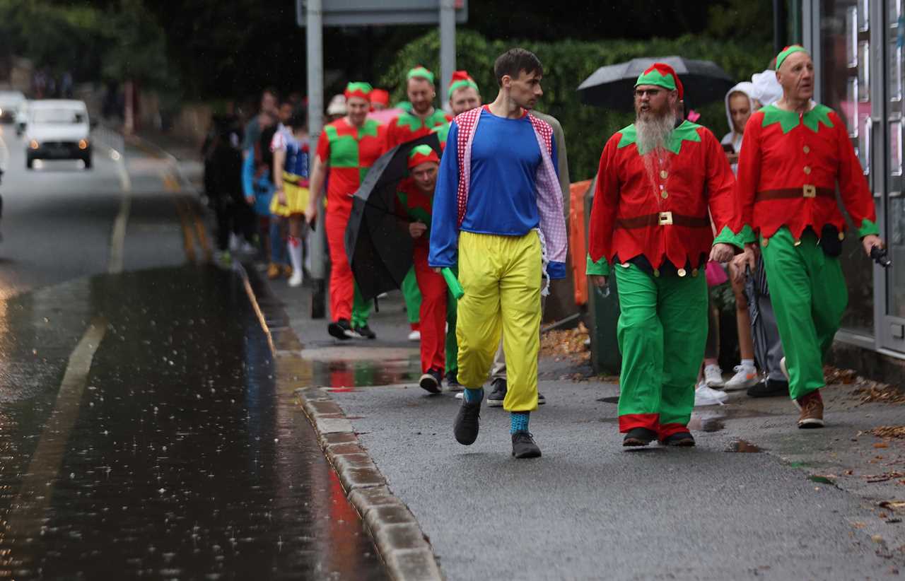 Revellers grin as they brave the rain to hit nightclubs and bars on wet night out