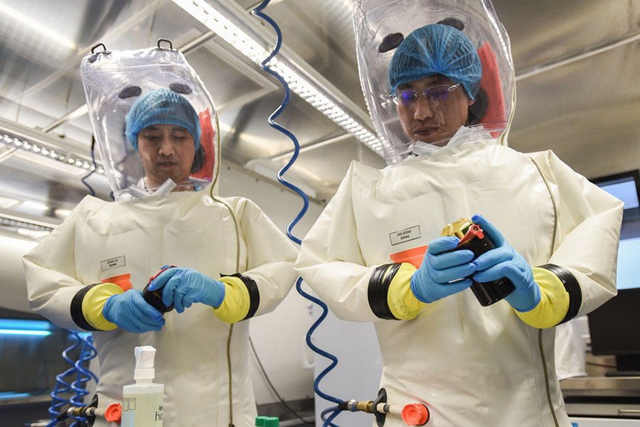 Scientists wearing protective suits at the Wuhan Institute of Virology 