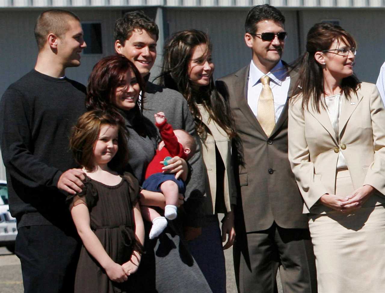 On the campaign trail in 2008. From left to right, son Track, daughter Piper, daughter Willow holding infant son Trig, Levi Johnston, boyfriend of daughter Bristol, and Palin's husband Todd.