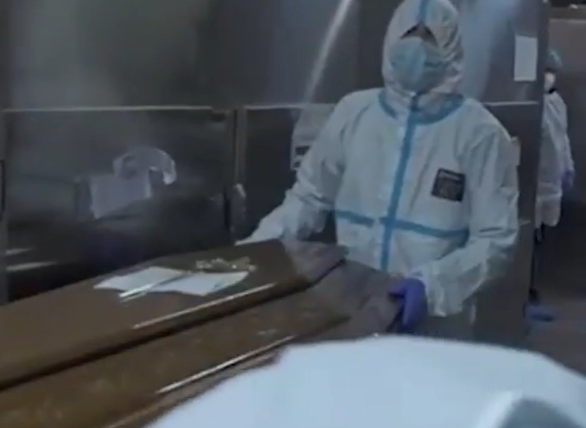 A coffin being taken out of a morgue in Romania